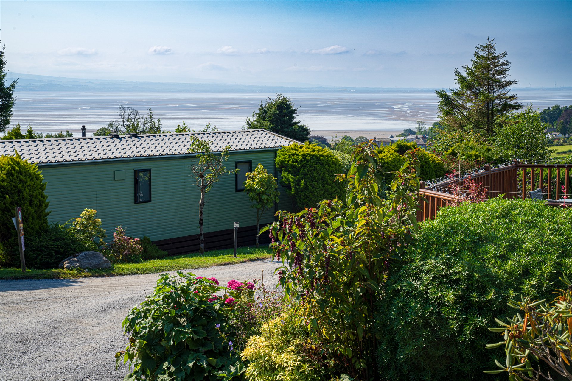 Colourful planting beside a holiday home with the Bay beyond