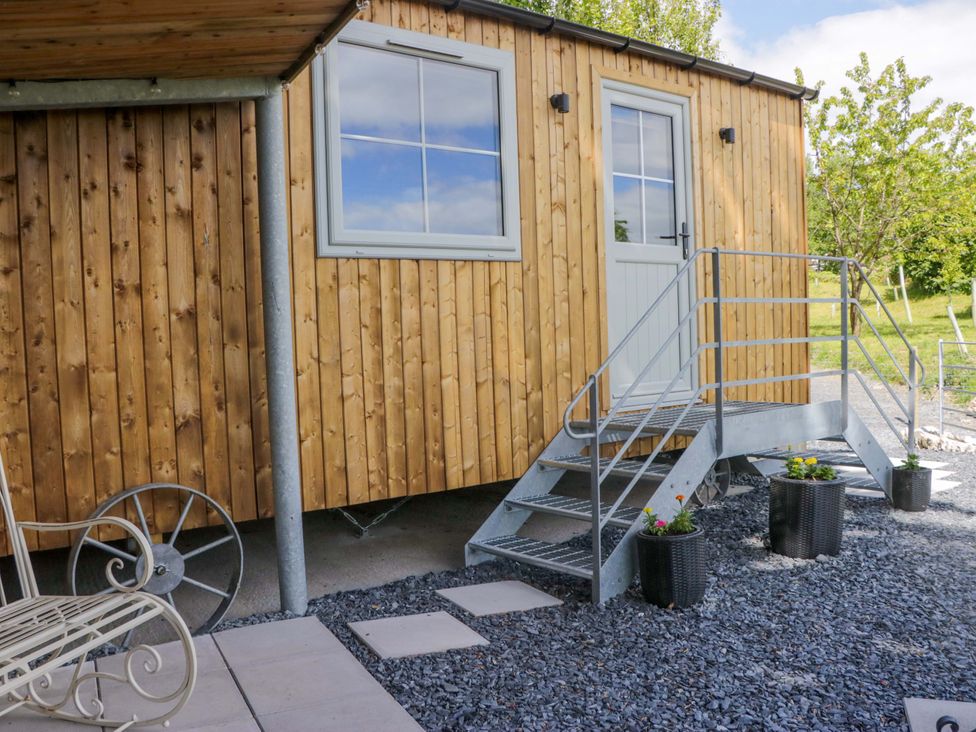 Timber-clad Little Hut with steps to its front door